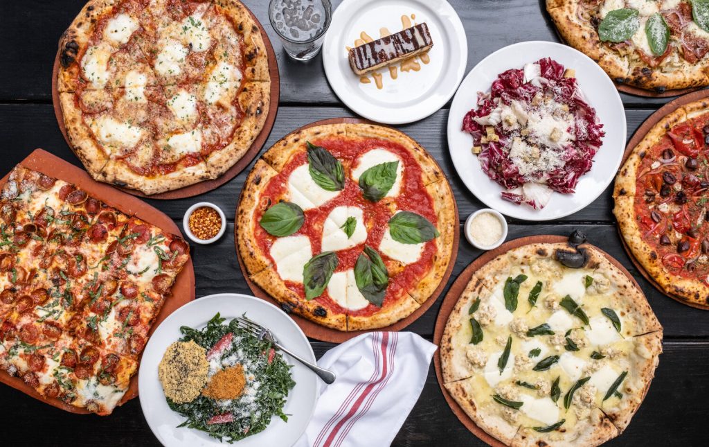 A spread of pizza from Oven and Shaker